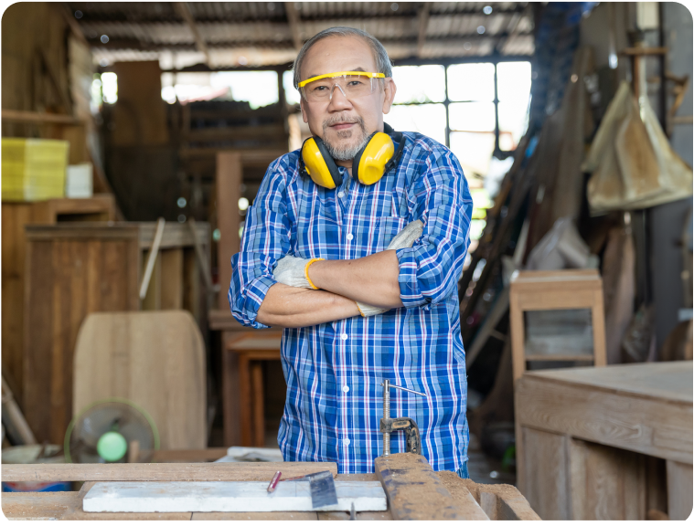 Brian standing with his arms crossed in a warehouse